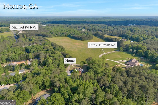 drone / aerial view with a wooded view