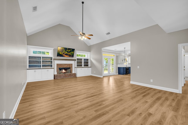 unfurnished living room with ceiling fan, baseboards, and light wood-style floors