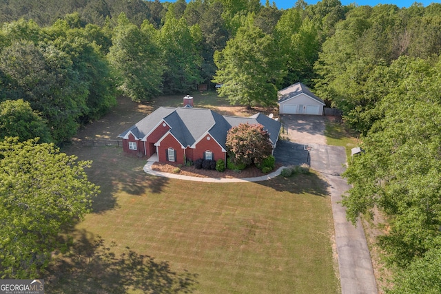 drone / aerial view with a wooded view