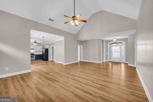 unfurnished living room with ceiling fan, visible vents, light wood finished floors, and high vaulted ceiling