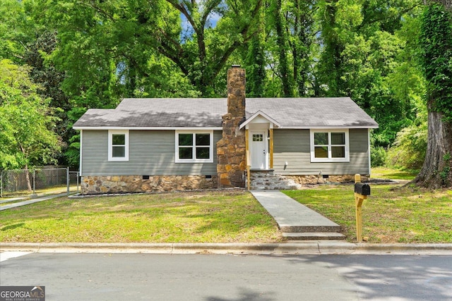 single story home featuring crawl space, fence, a chimney, and a front yard