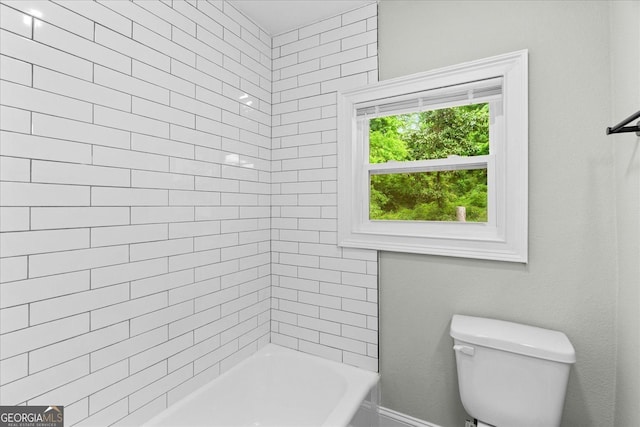 bathroom with toilet and bathing tub / shower combination