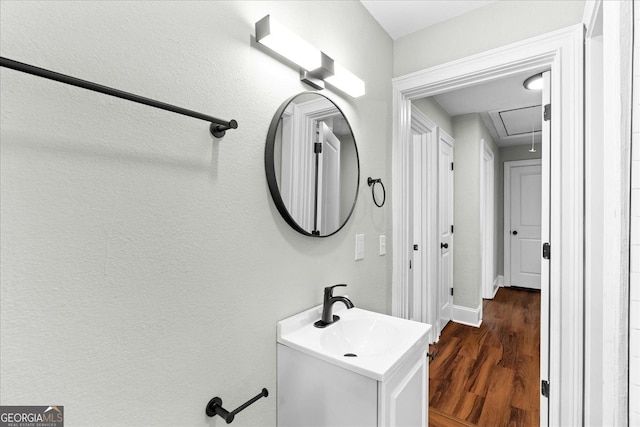 bathroom featuring vanity, baseboards, and wood finished floors