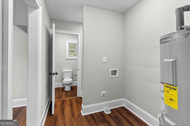 interior space featuring dark wood-type flooring, hookup for a washing machine, baseboards, and electric water heater
