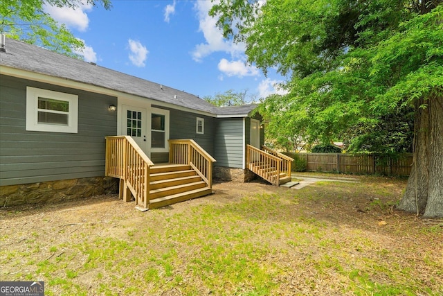 rear view of property with fence