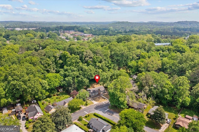 drone / aerial view featuring a forest view