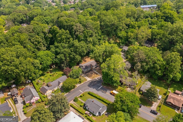 aerial view featuring a wooded view and a residential view
