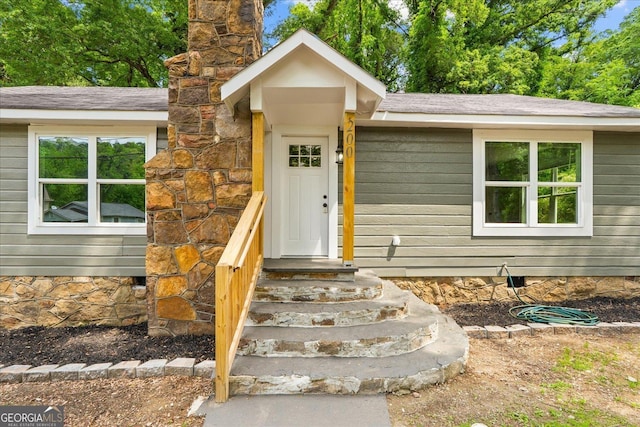 view of exterior entry featuring a chimney