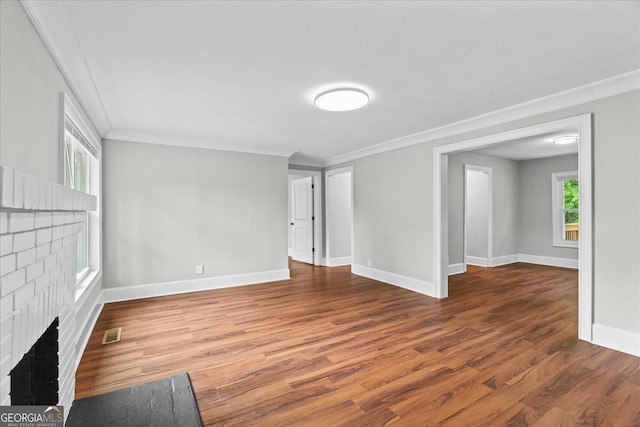 unfurnished living room featuring ornamental molding, a fireplace, and visible vents