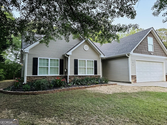 view of front of property with a front yard, concrete driveway, stone siding, and a shingled roof