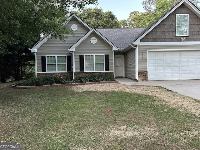 view of front of home featuring driveway, a front yard, an attached garage, stone siding, and roof with shingles