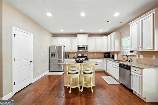 245 Tapestry Dr, Mcdonough, GA 30252 - kitchen with a sink, appliances with stainless steel finishes, decorative backsplash, and a kitchen island