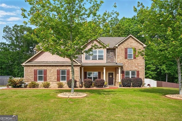 245 Tapestry Dr, Mcdonough, GA 30252 - craftsman house with brick siding, a front lawn, and fence