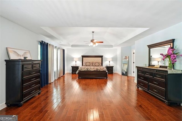 245 Tapestry Dr, Mcdonough, GA 30252 - bedroom with dark wood-style flooring, baseboards, and a raised ceiling