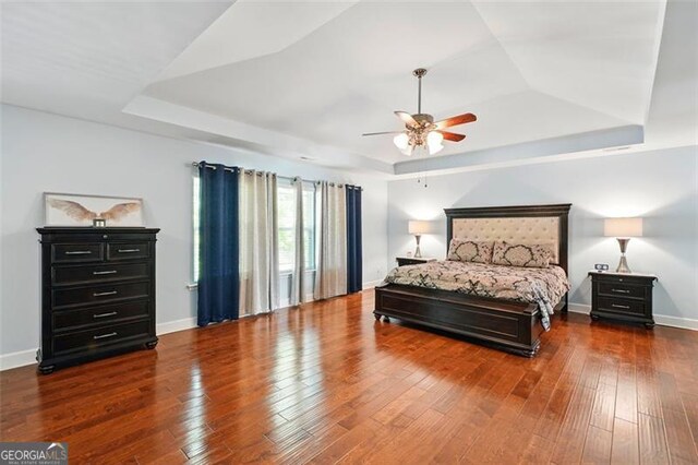 245 Tapestry Dr, Mcdonough, GA 30252 - bedroom with a ceiling fan, a tray ceiling, baseboards, and wood finished floors