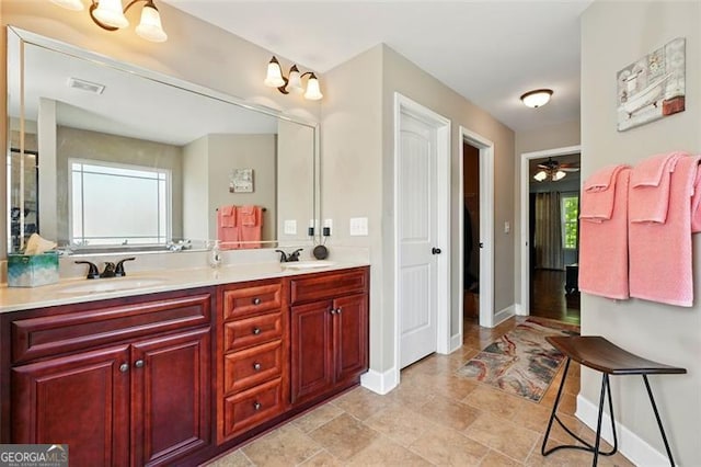 245 Tapestry Dr, Mcdonough, GA 30252 - full bathroom featuring double vanity, baseboards, visible vents, and a sink