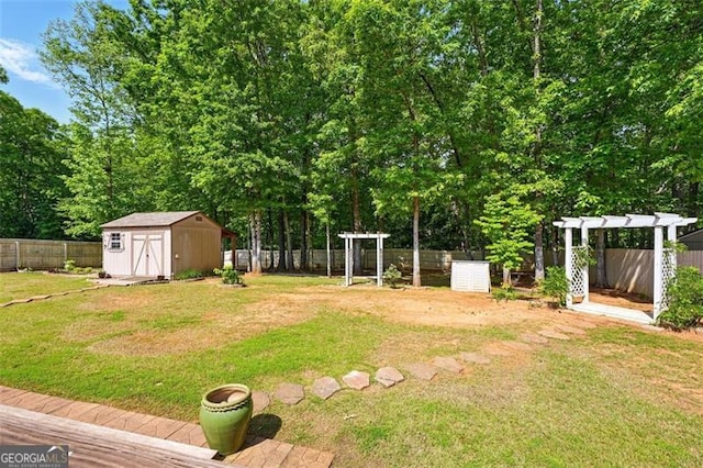 245 Tapestry Dr, Mcdonough, GA 30252 - view of yard with a storage shed, a pergola, an outdoor structure, and a fenced backyard