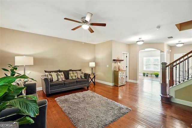 245 Tapestry Dr, Mcdonough, GA 30252 - living room with baseboards, arched walkways, stairs, and ceiling fan
