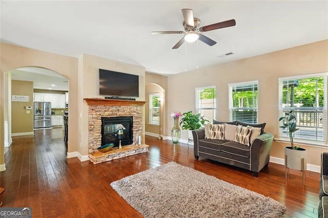245 Tapestry Dr, Mcdonough, GA 30252 - living area with dark wood-style flooring, ceiling fan, and arched walkways