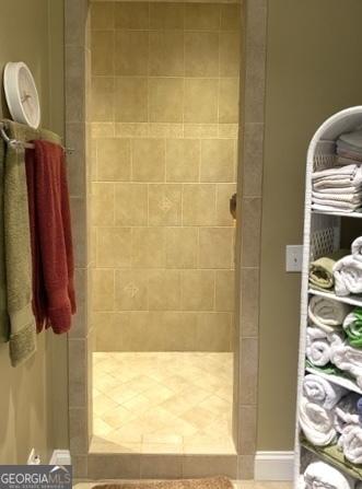 bathroom with tiled shower
