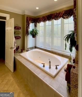 full bath featuring tile patterned flooring, ornamental molding, a garden tub, and recessed lighting