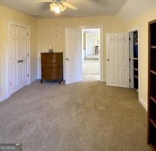 unfurnished bedroom featuring ceiling fan, carpet, and lofted ceiling