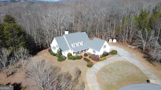 drone / aerial view featuring a forest view