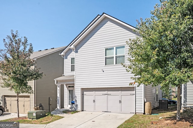 875 Venture Way SW, Atlanta, GA 30331 - view of front of property with a garage, central air condition unit, and concrete driveway