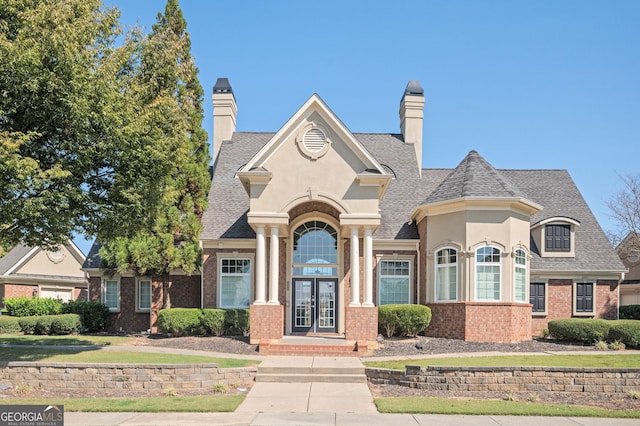 875 Venture Way SW, Atlanta, GA 30331 - french country style house with brick siding, roof with shingles, stucco siding, and french doors