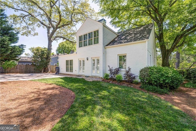 rear view of house with french doors and brick siding