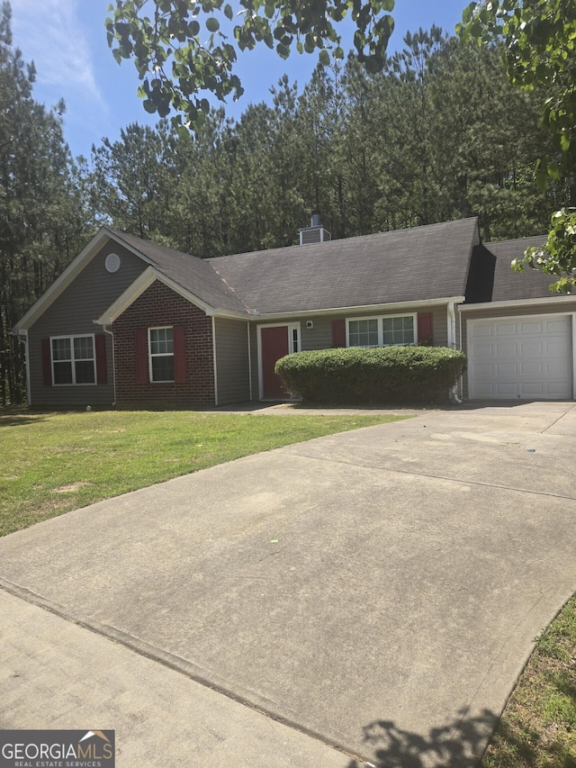 310 Wolf Creek Cv, South Fulton, GA 30349 - ranch-style home featuring a garage, concrete driveway, a front lawn, and brick siding