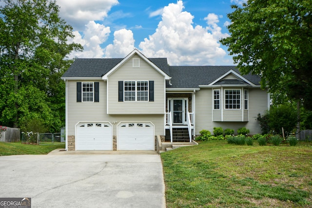 view of front of house with a garage, fence, a front yard, and concrete driveway
