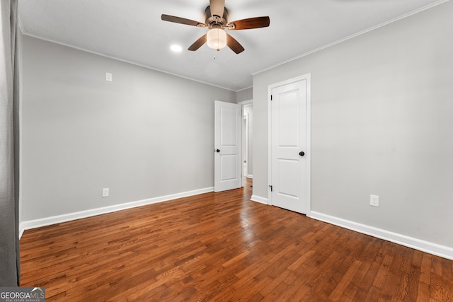 empty room with ceiling fan, baseboards, ornamental molding, and wood finished floors