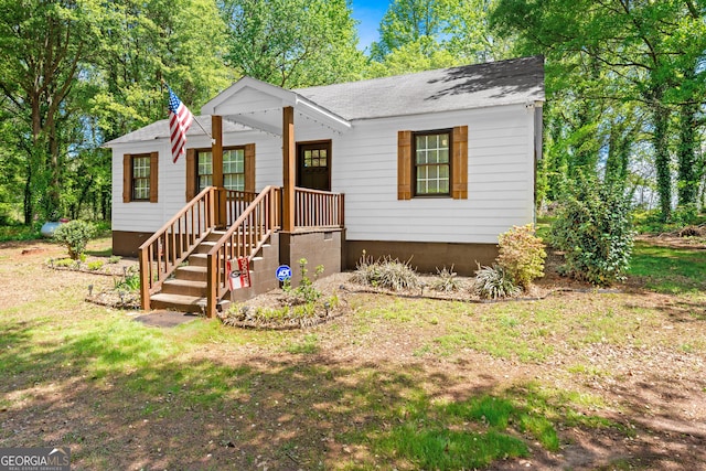 bungalow featuring a shingled roof