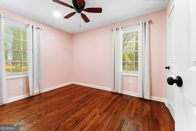 unfurnished room with a ceiling fan, baseboards, visible vents, and wood finished floors