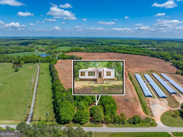 aerial view with a water view and a wooded view