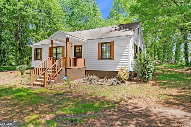 view of front of house featuring roof with shingles
