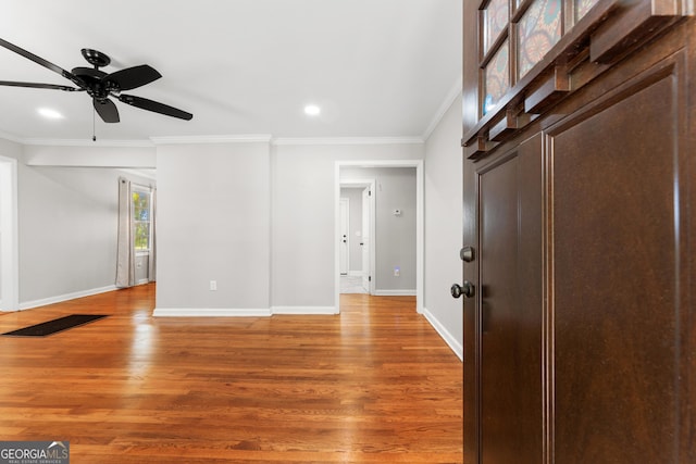 interior space with crown molding, ceiling fan, recessed lighting, baseboards, and light wood-type flooring