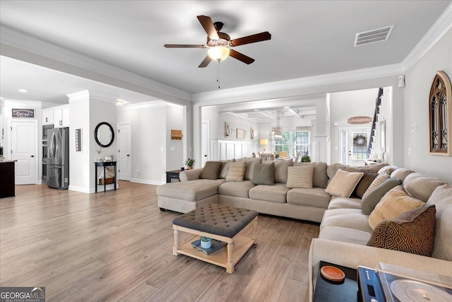 4575 Birch Way, Loganville, GA 30052 - living room featuring a ceiling fan, light wood-type flooring, ornamental molding, and baseboards
