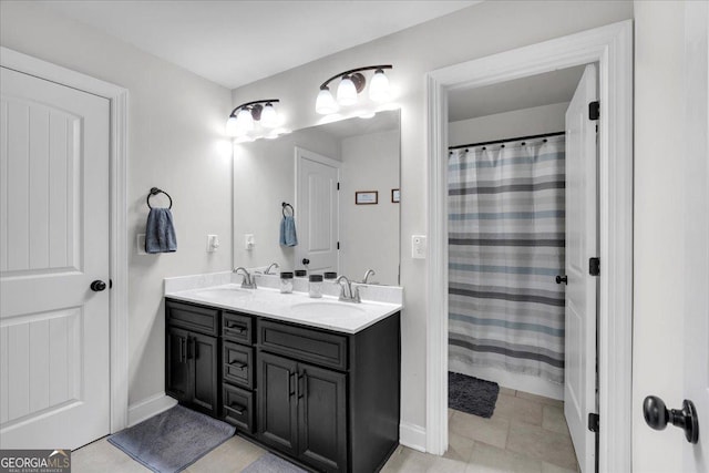 4575 Birch Way, Loganville, GA 30052 - bathroom featuring double vanity and baseboards