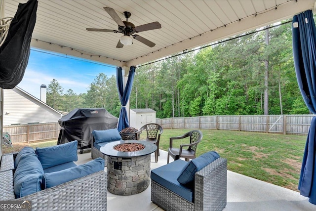 4575 Birch Way, Loganville, GA 30052 - view of patio featuring a storage unit, an outdoor living space with a fire pit, ceiling fan, an outbuilding, and a view of trees