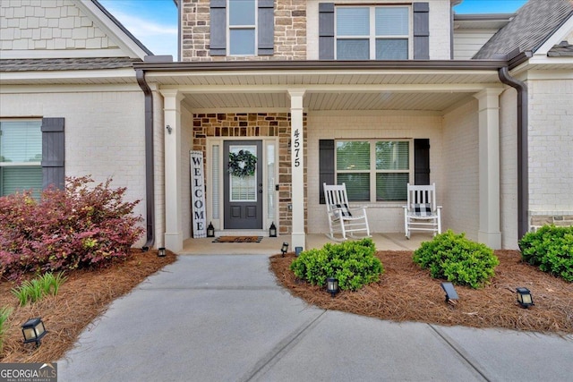4575 Birch Way, Loganville, GA 30052 - view of exterior entry featuring covered porch, brick siding, and stone siding