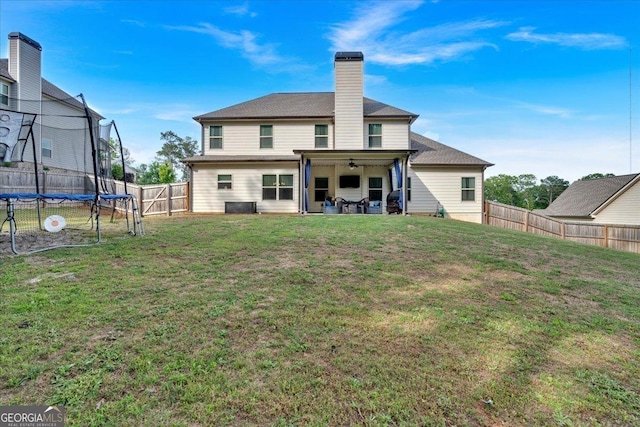 4575 Birch Way, Loganville, GA 30052 - back of property featuring a trampoline, a patio area, a chimney, and ceiling fan