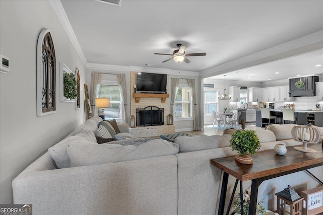 4575 Birch Way, Loganville, GA 30052 - living area with a ceiling fan, crown molding, and a brick fireplace