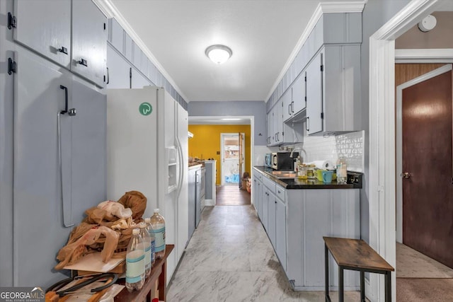 829 Berkshire Dr, Washington, GA 30673 - kitchen featuring decorative backsplash, dark countertops, separate washer and dryer, a sink, and white fridge with ice dispenser