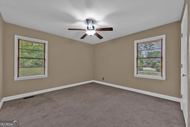 829 Berkshire Dr, Washington, GA 30673 - empty room featuring a ceiling fan, a wealth of natural light, and dark carpet