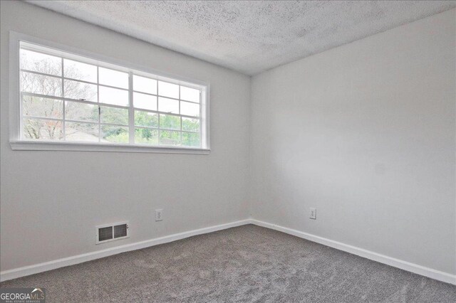 4701 Flat Shoals Rd Unit 35E, Union City, GA 30291 - carpeted spare room with a textured ceiling and baseboards