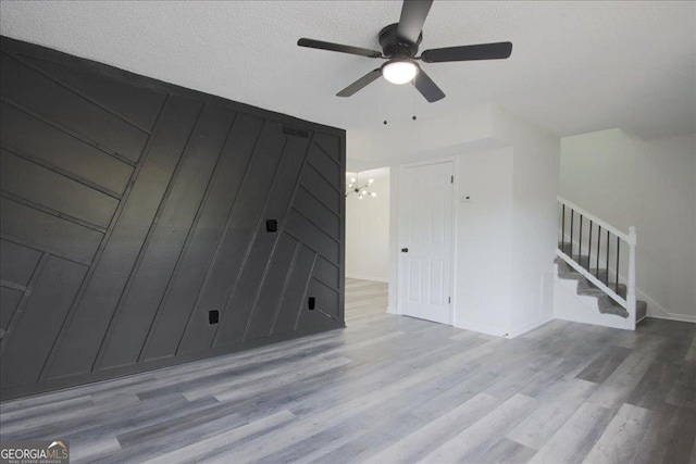 4701 Flat Shoals Rd Unit 35E, Union City, GA 30291 - unfurnished living room featuring stairs, ceiling fan, wood finished floors, and a chandelier
