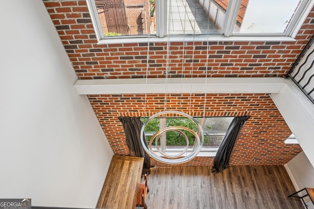 detailed view of wood finished floors and brick wall