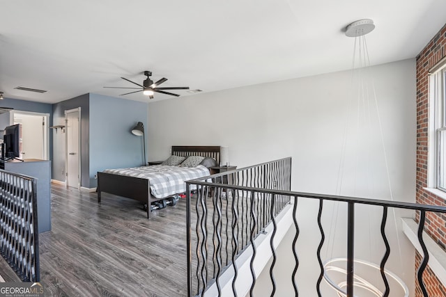 bedroom with wood finished floors, ceiling fan, and baseboards
